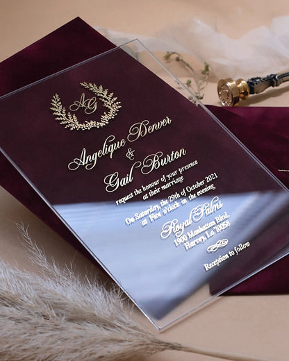 Monogram I Acrylic clear acrylic wedding invitation close-up with gold foil laurel monogram on Burgundy velvet — Polina Perri