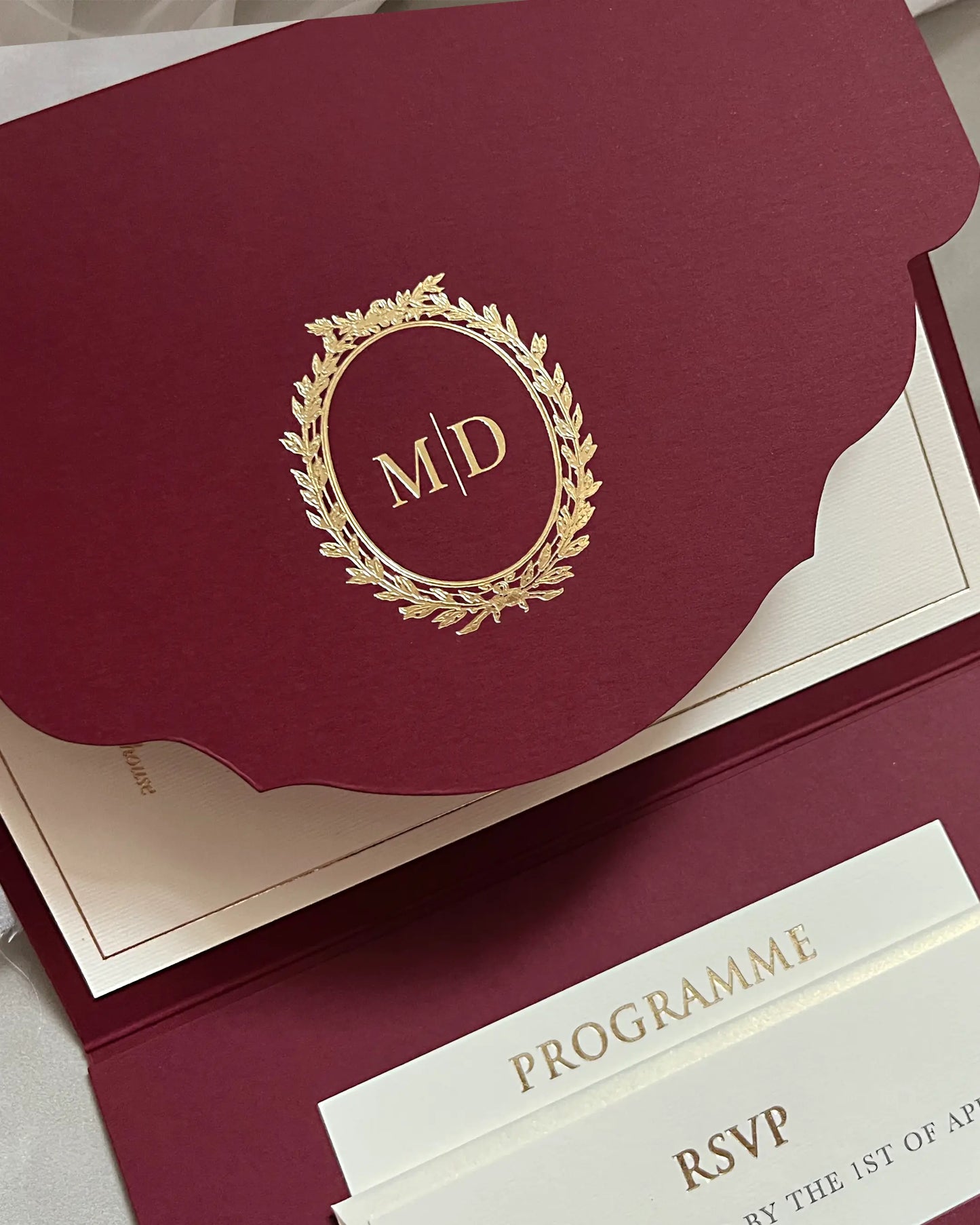 Cecile Burgundy pocketfold cover with gold monogram wreath, programme and RSVP inserts — Polina Perri