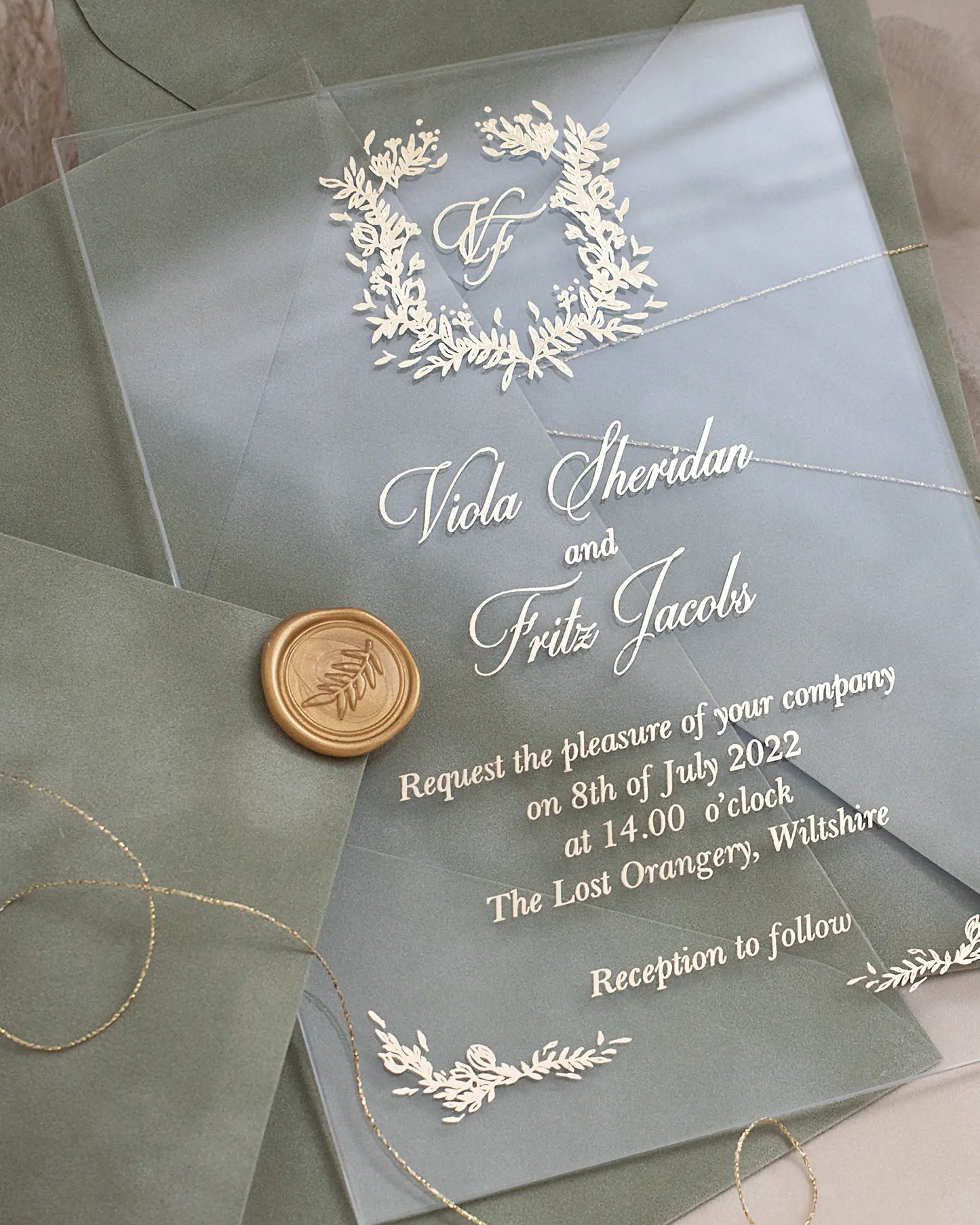 Fiori Acrylic Wedding Invitation close-up with white foil botanical wreath monogram and gold wax seal — Polina Perri