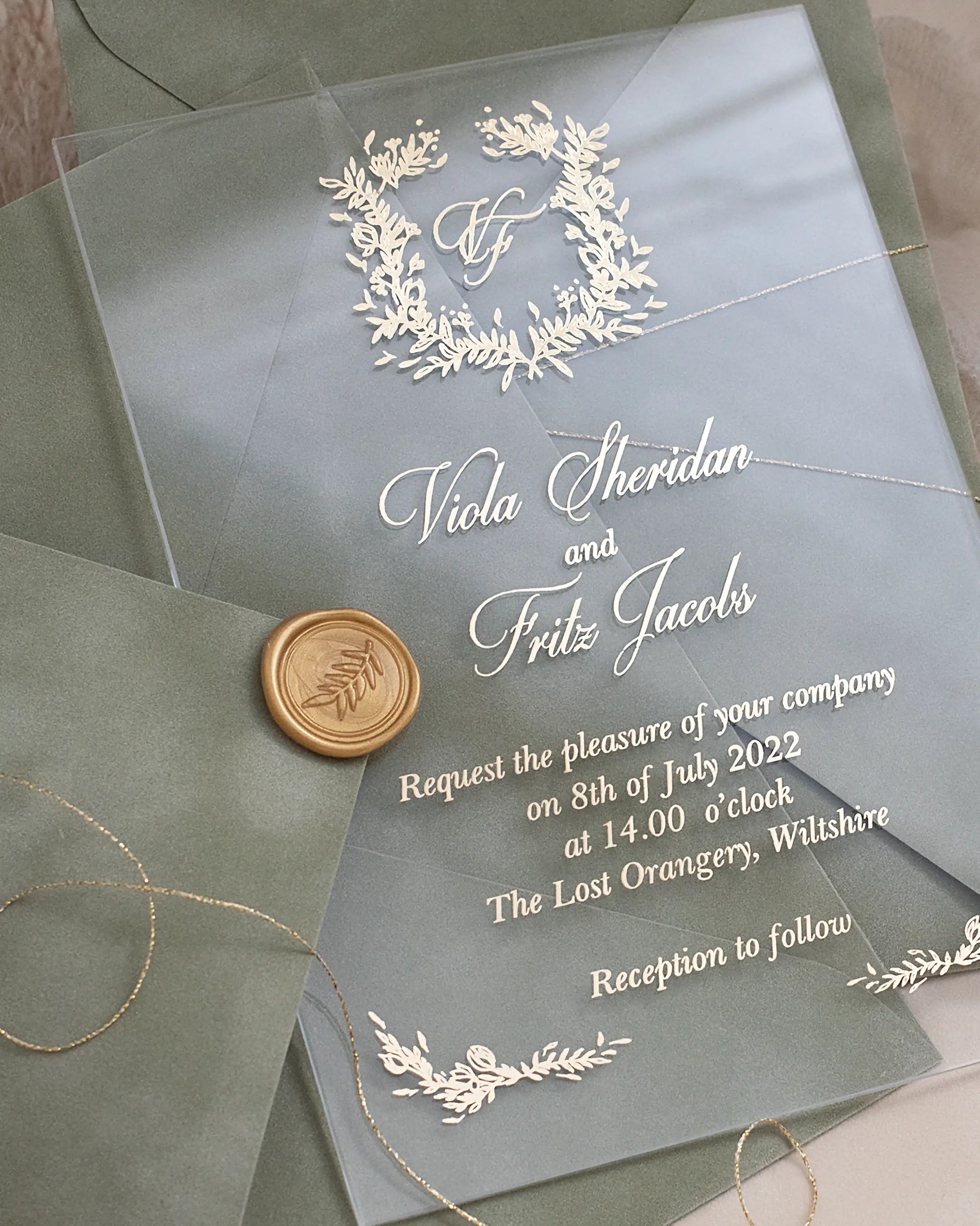 Fiori Acrylic Wedding Invitation close-up with white foil botanical wreath monogram and gold wax seal — Polina Perri