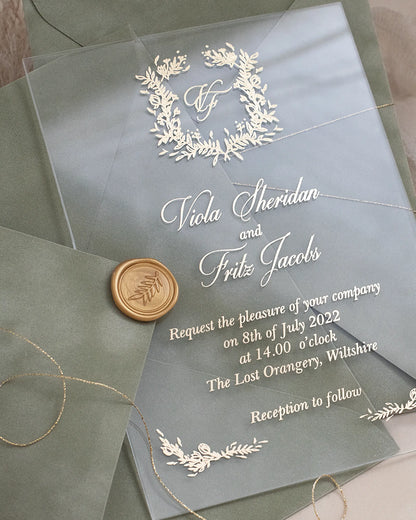 Fiori Acrylic Wedding Invitation close-up with white foil botanical wreath monogram and gold wax seal — Polina Perri