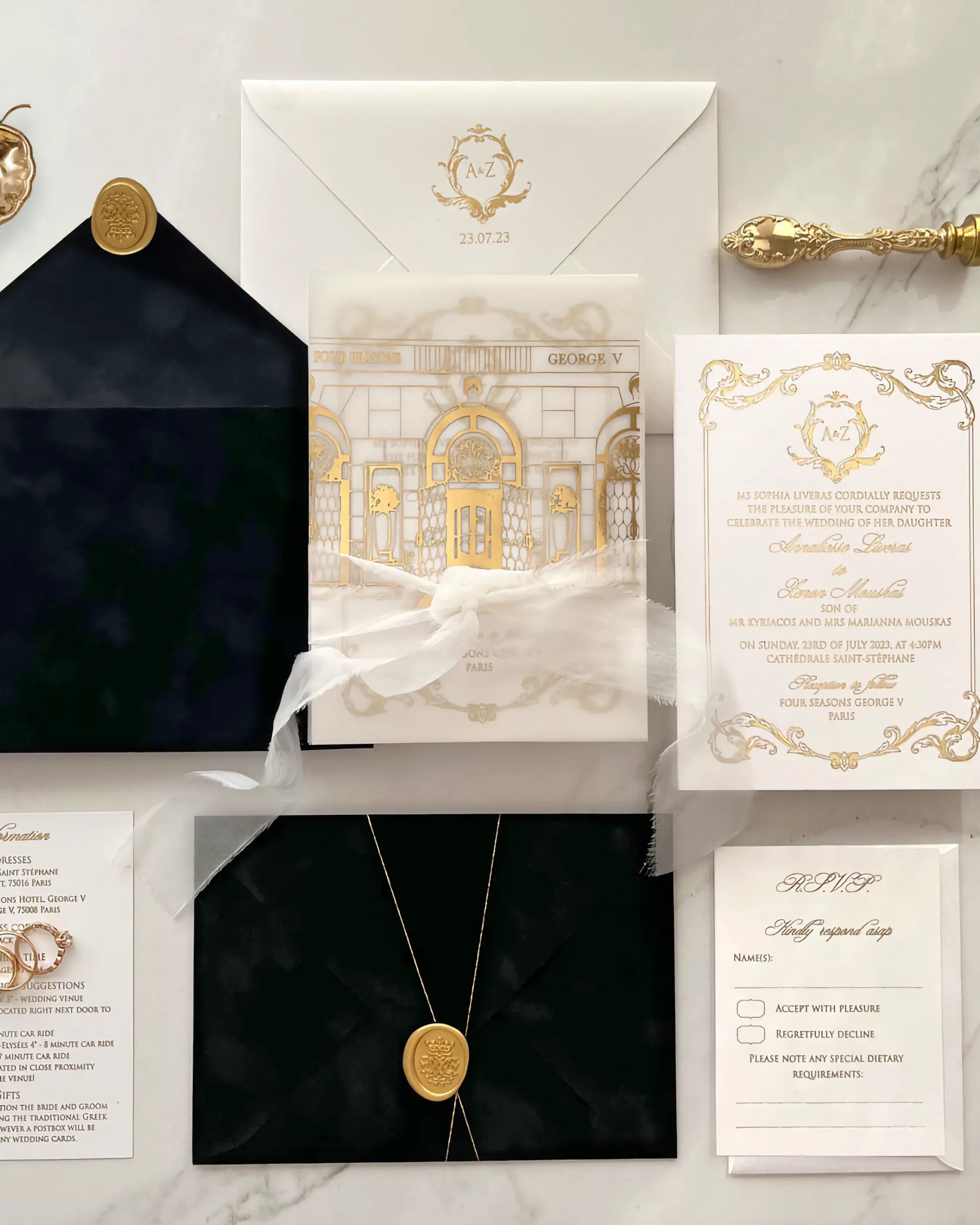 Luxurious invitation set with gold and black design on a marble surface