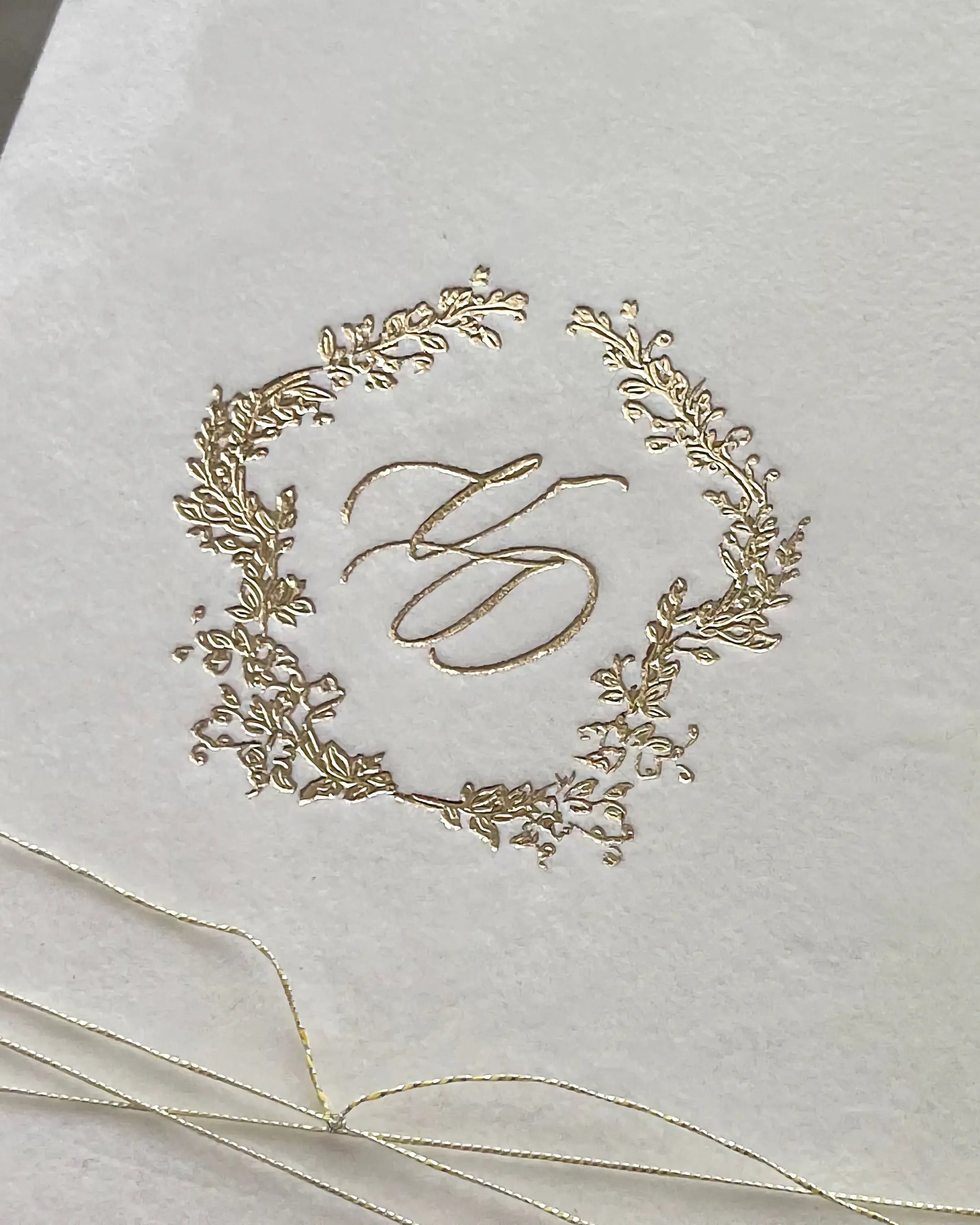 Virginie White velvet pocketfold cover with gold foil monogram wreath close-up — Polina Perri