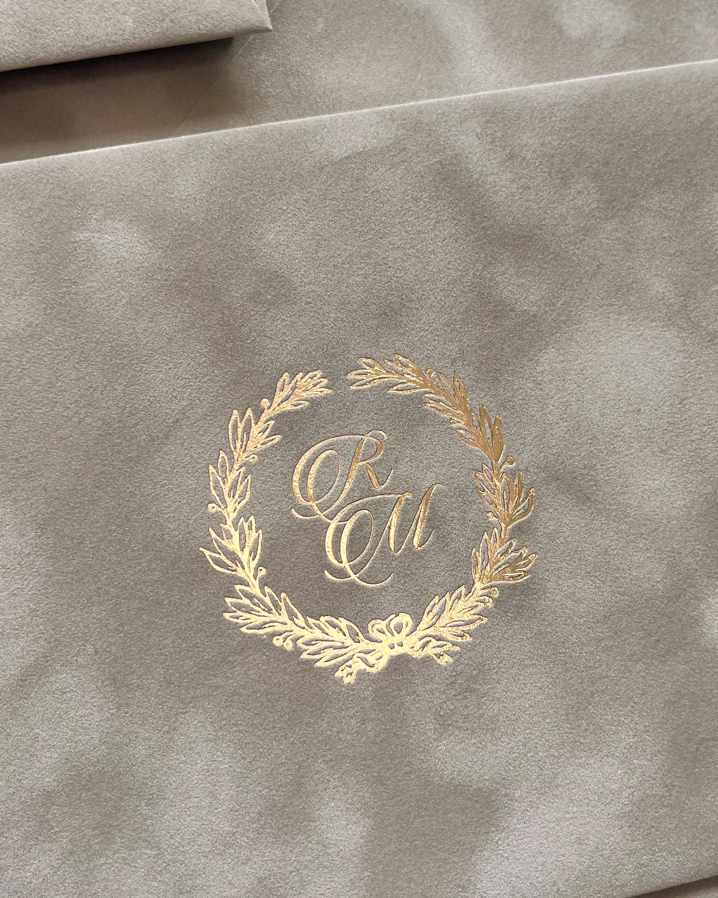 Platine Velvet Envelope close-up with gold foil laurel wreath monogram — Polina Perri