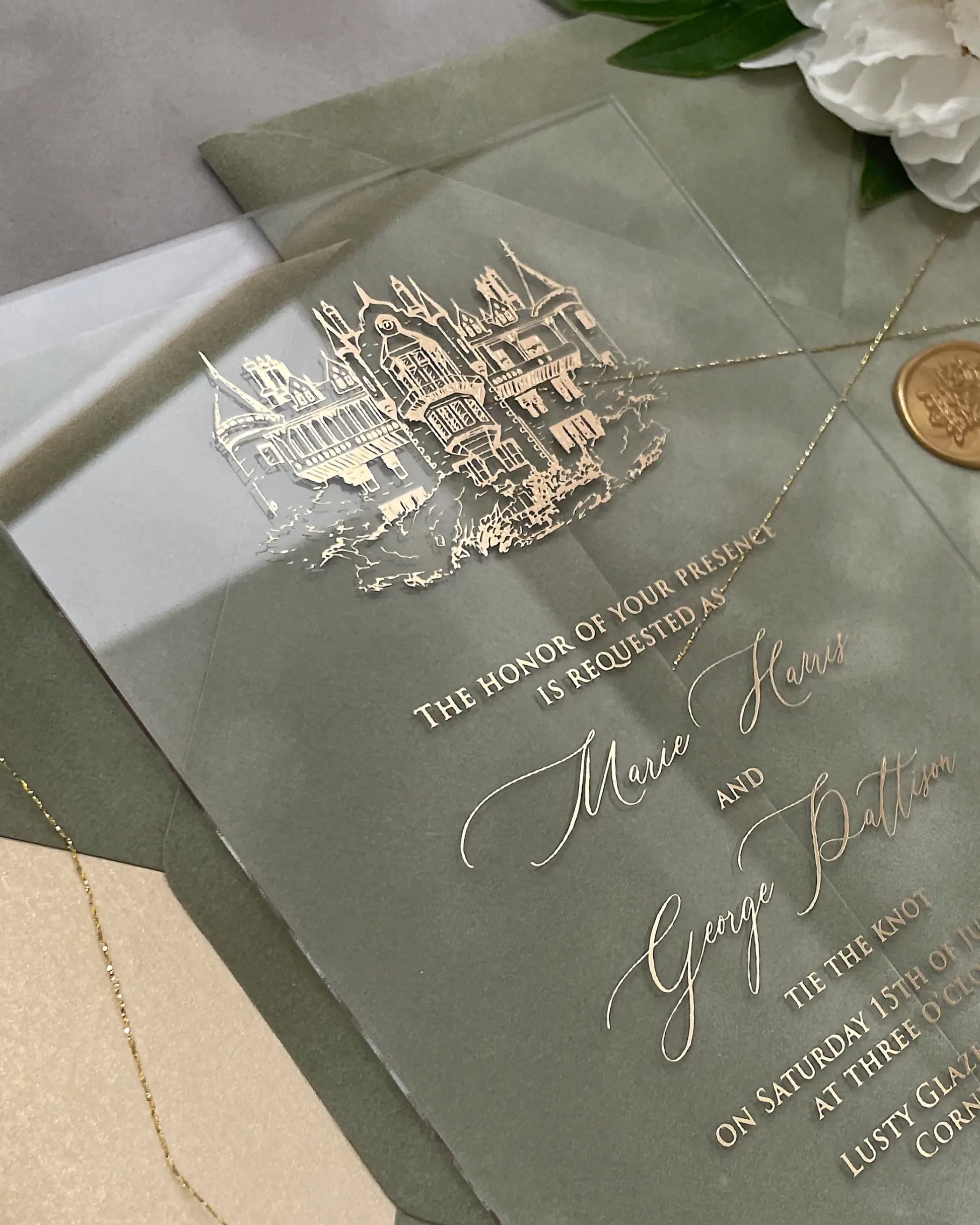 Venue Acrylic Wedding Invitation close-up with gold foil castle illustration and script wording — Polina Perri