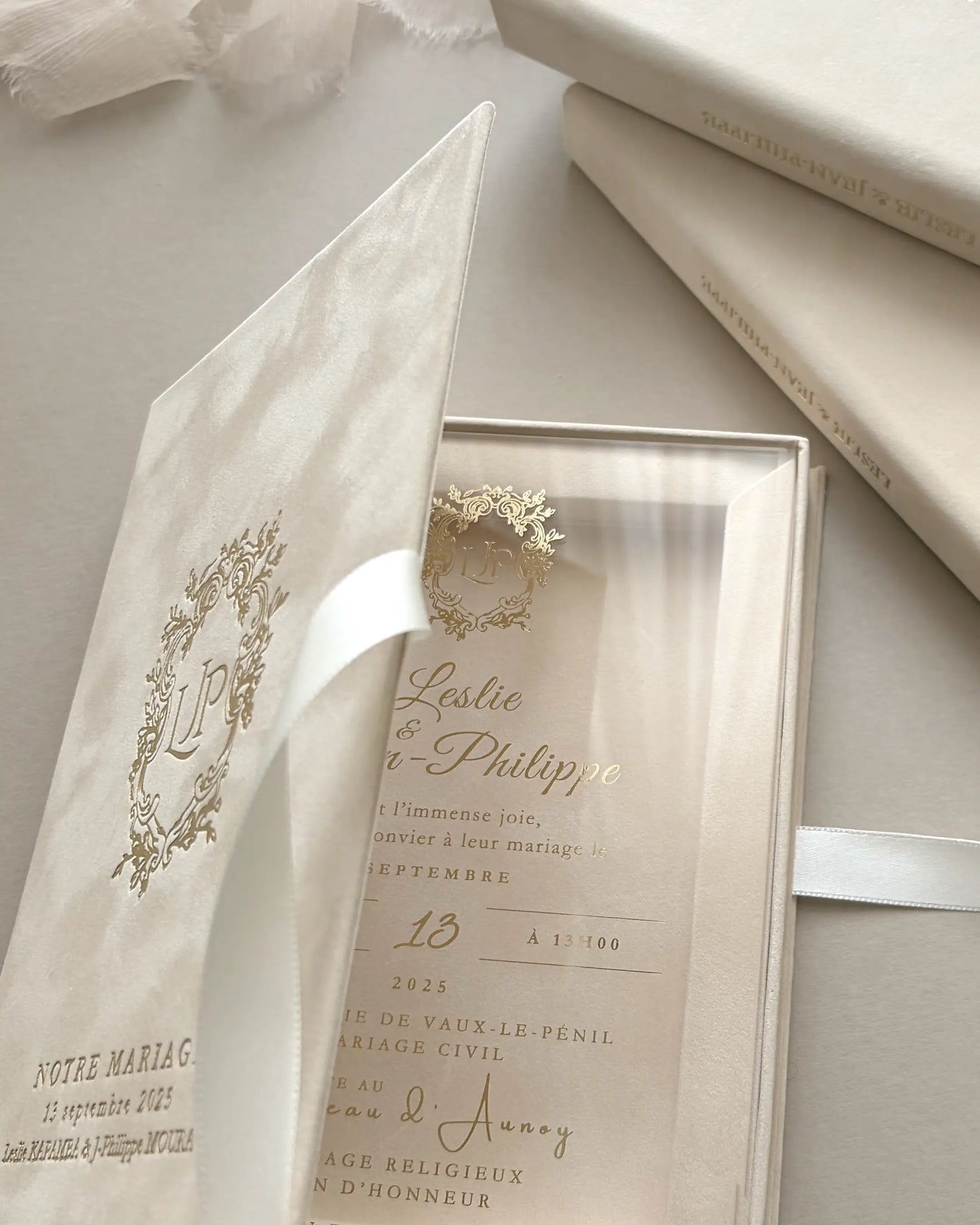 Opening a luxury blush velvet wedding invitation box to reveal a premium clear acrylic card with elegant gold lettering and white satin ribbon — Polina Perri