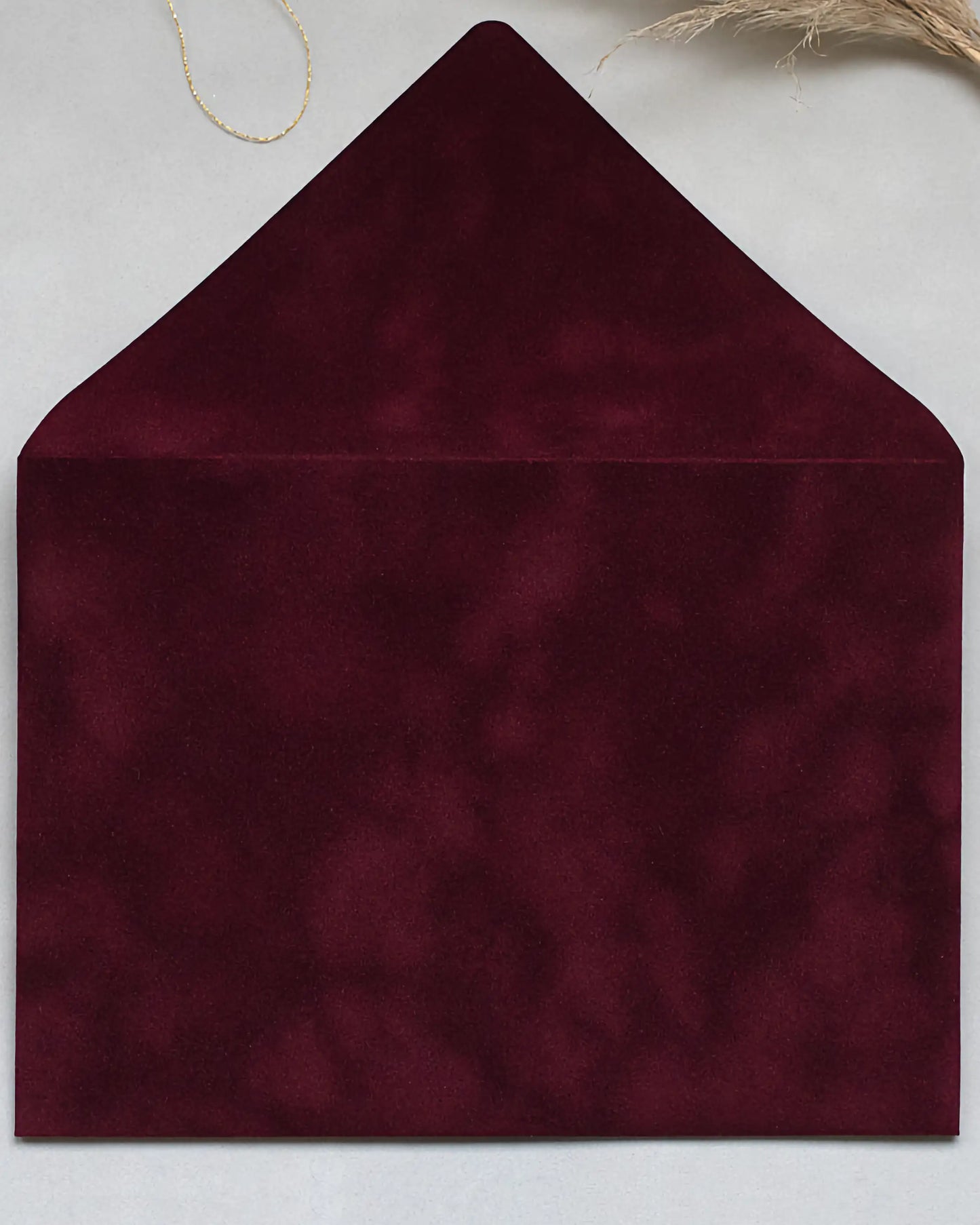 Burgundy velvet envelope flat lay close-up — Polina Perri