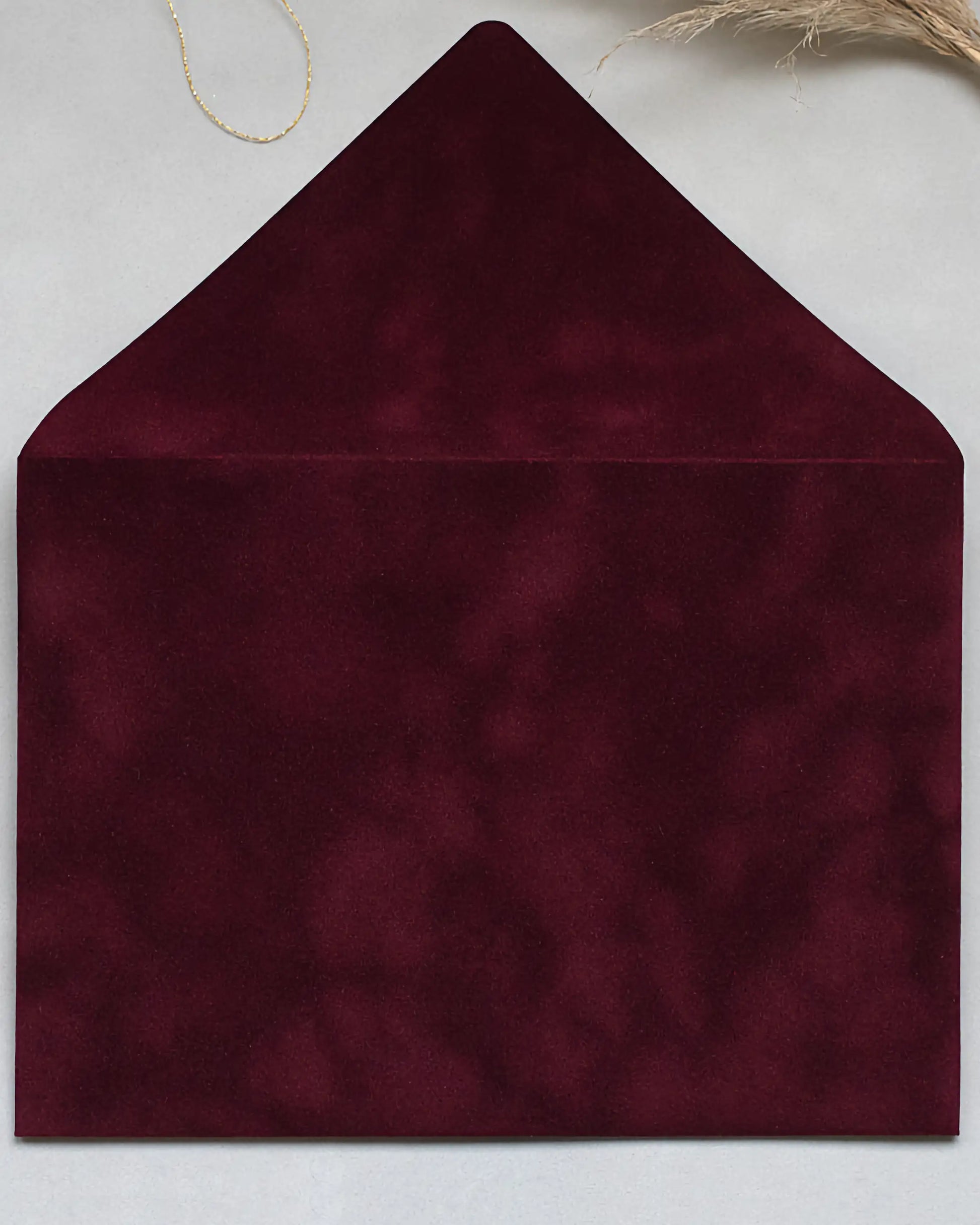 Burgundy velvet envelope flat lay close-up — Polina Perri