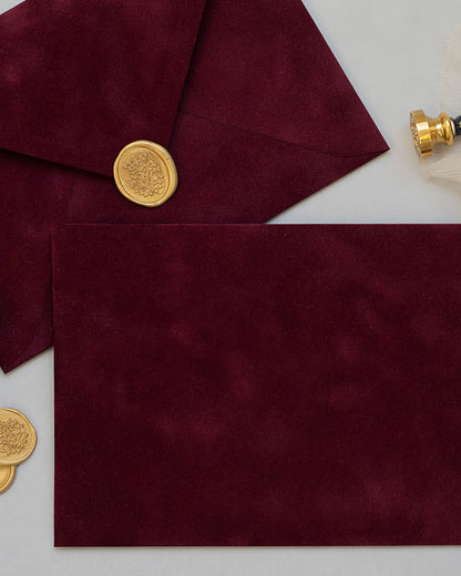 Burgundy velvet envelopes with gold wax seal close-up — Polina Perri