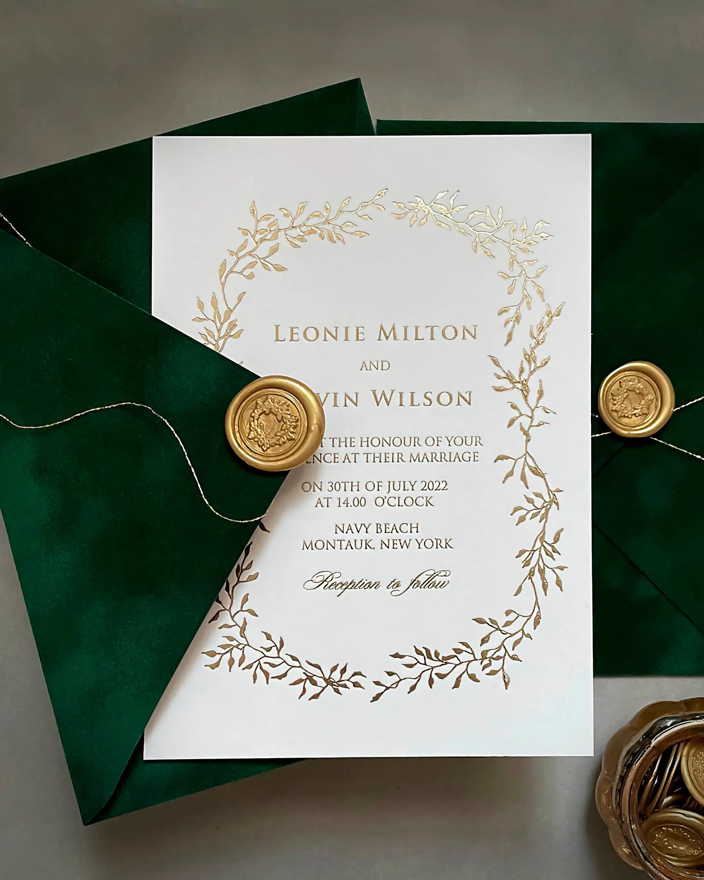 Celeste Gold foil pressed wedding invitation with an elegant botanical foliage frame on thick white cotton card stock, paired with a forest green velvet envelope and gold wax seal — Polina Perri