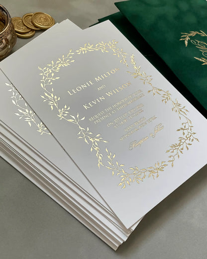 A stack of premium Celeste wedding invitations displaying the luxurious 600gsm heavy paper stock and reflective hot stamped gold foil borders — Polina Perri