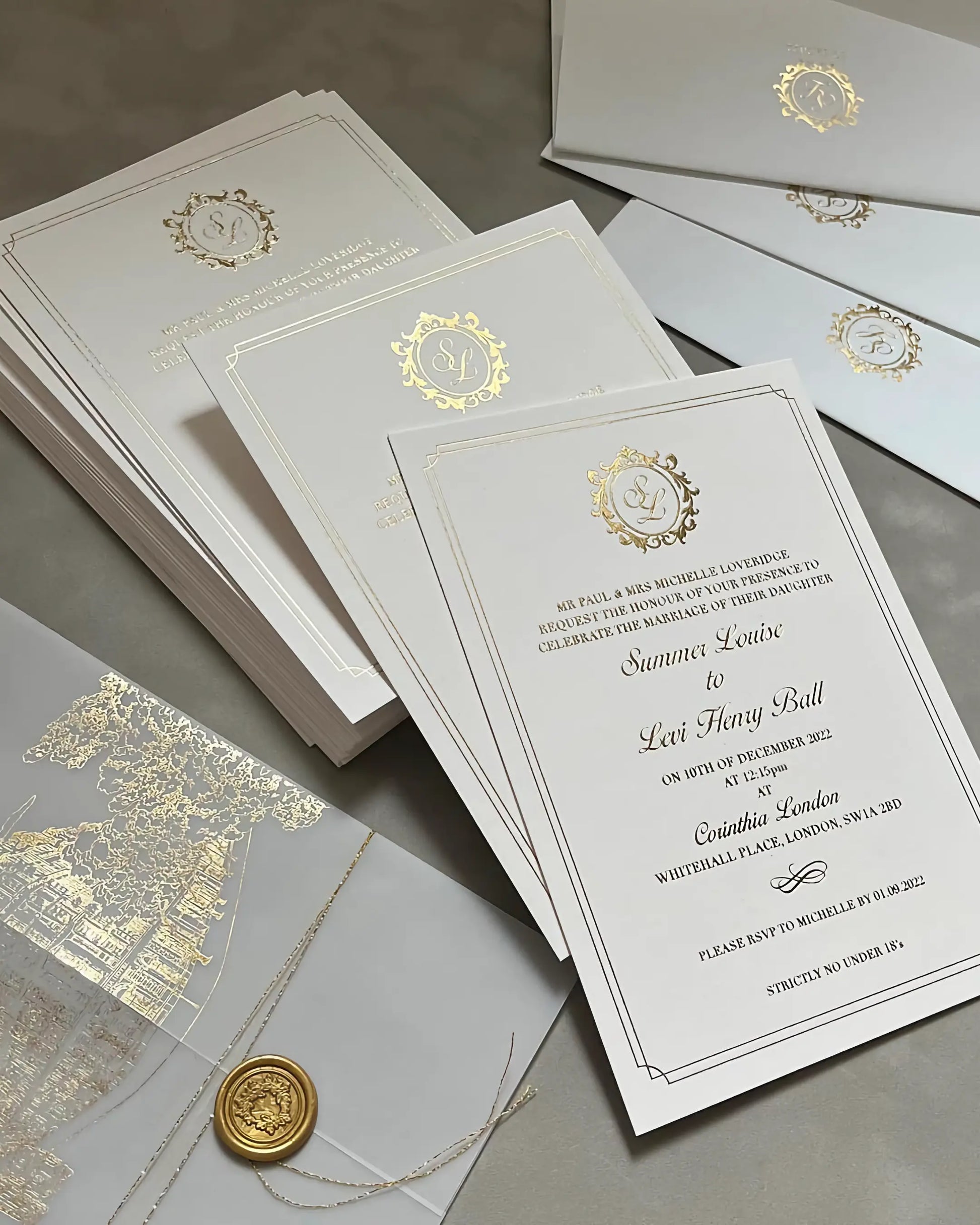 Luxury Corinthia wedding stationery suite with gold foil venue illustrations, vellum jackets, and premium white envelopes printed with elegant gold monograms — Polina Perri