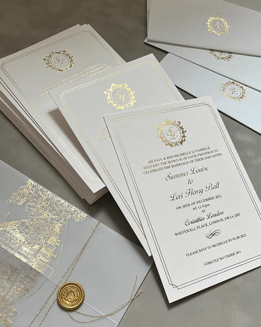 Luxury Corinthia wedding stationery suite with gold foil venue illustrations, vellum jackets, and premium white envelopes printed with elegant gold monograms — Polina Perri