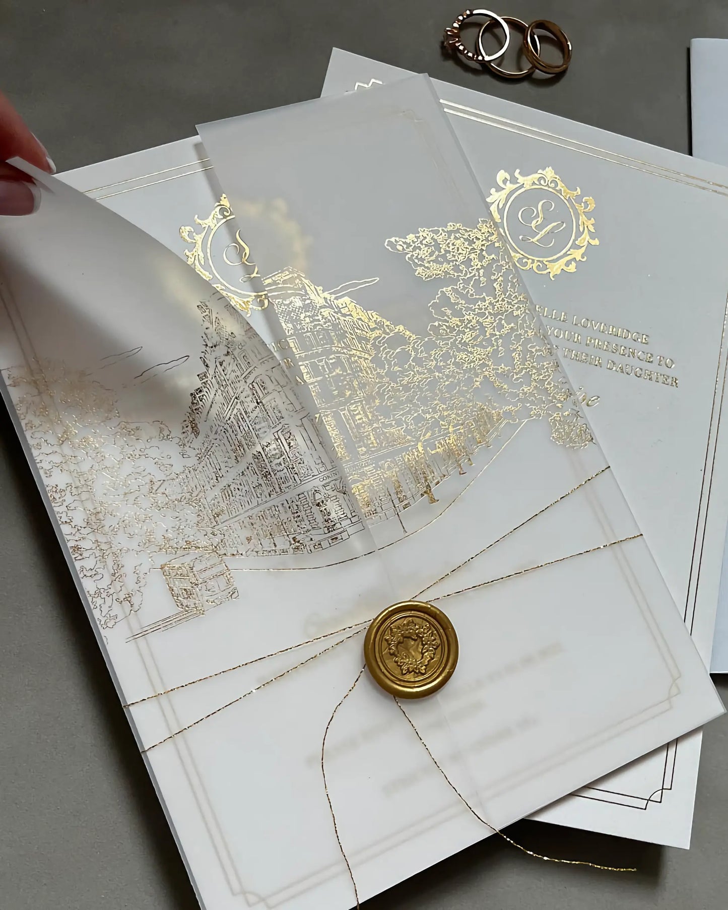 Corinthia XL gold foil wedding invitation with an intricate venue illustration on thick cotton paper, enclosed in a gatefold vellum jacket with gold string and wax seal — Polina Perri