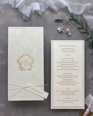 Sophisticated cream velvet wedding menu board styled with an elegant gold foil monogram cover and a fine textured paper course checklist — Polina Perri