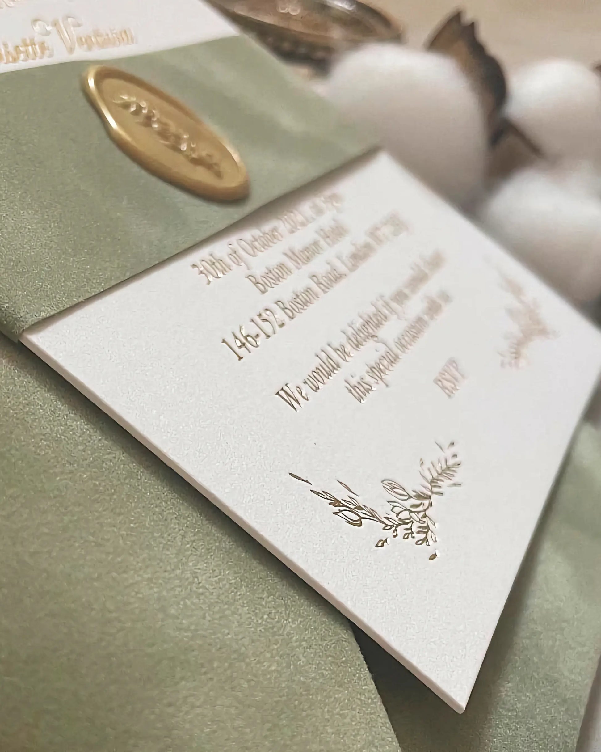Close-up perspective of the Fiori wedding invitation card showing the crisp gold foil stamped text and a premium gold wax seal on heavy cotton stock — Polina Perri