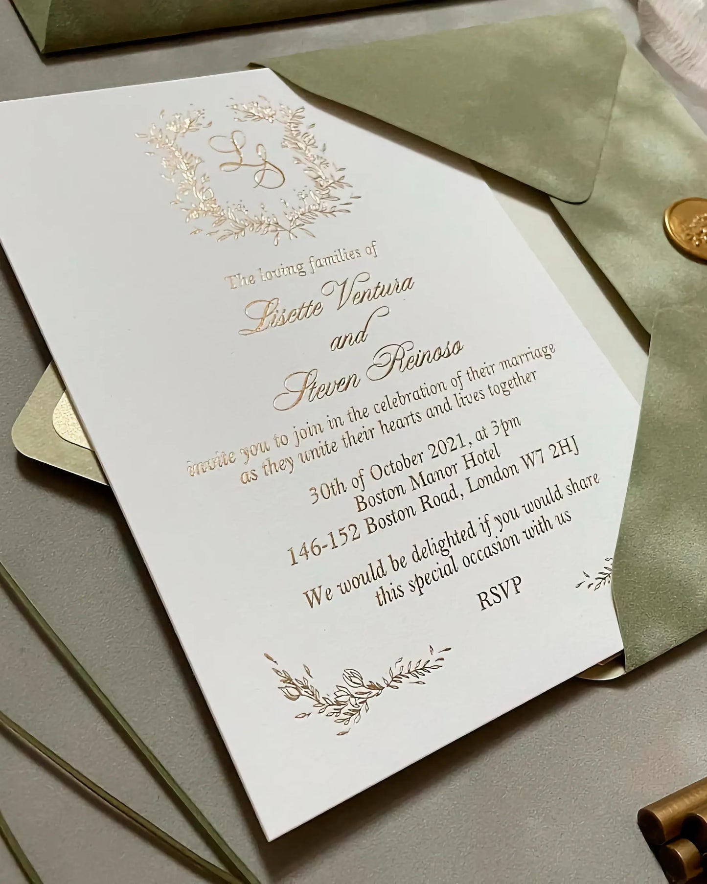 Top view of the Fiori wedding invitation with hot stamped gold foil botanical frame, beautifully paired with a matte designer sage green envelope — Polina Perri