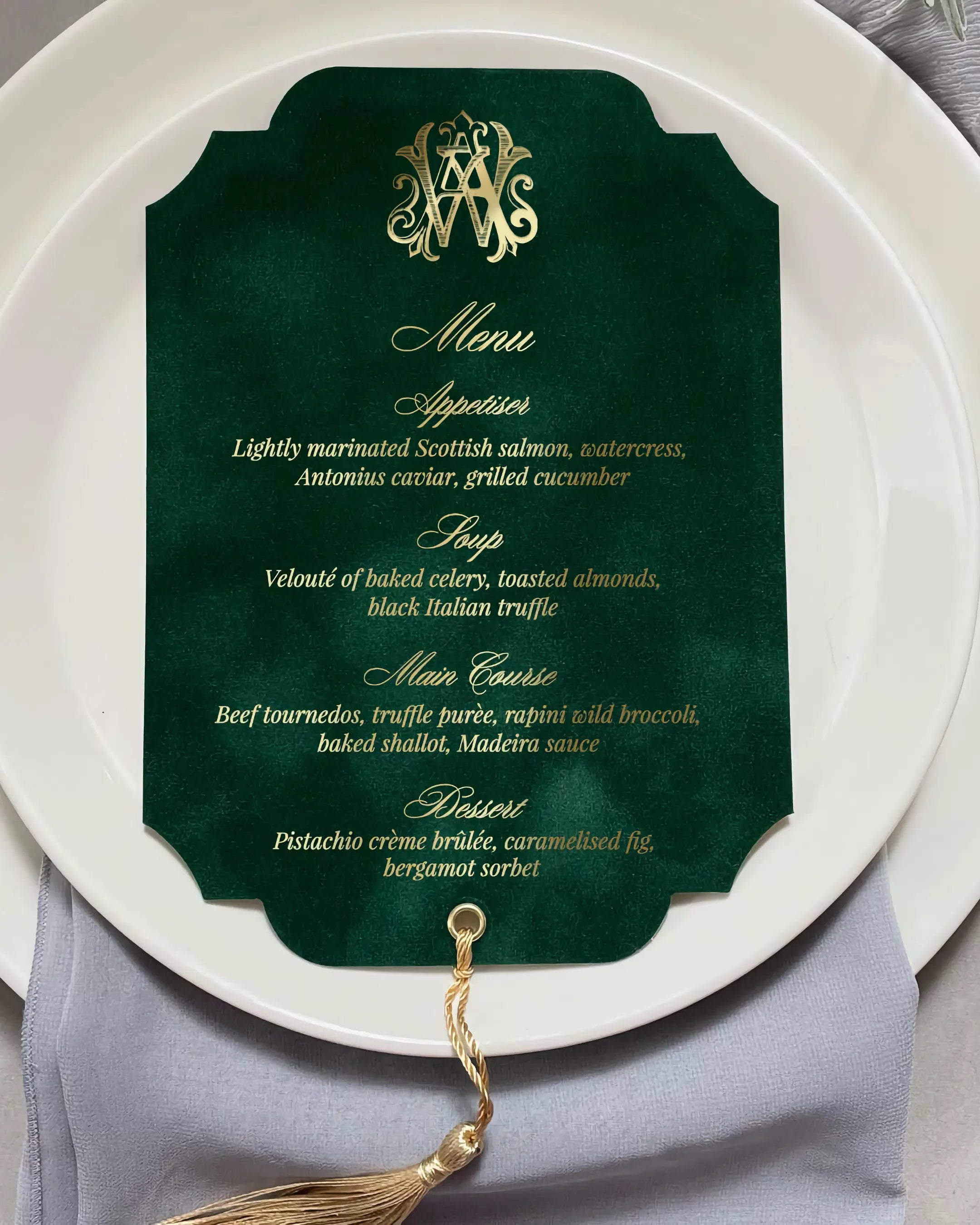 Luxury wedding menu card crafted from forest green velvet with a die-cut vintage frame shape, shimmering gold foil hot pressed text, and a golden silk tassel — Polina Perri