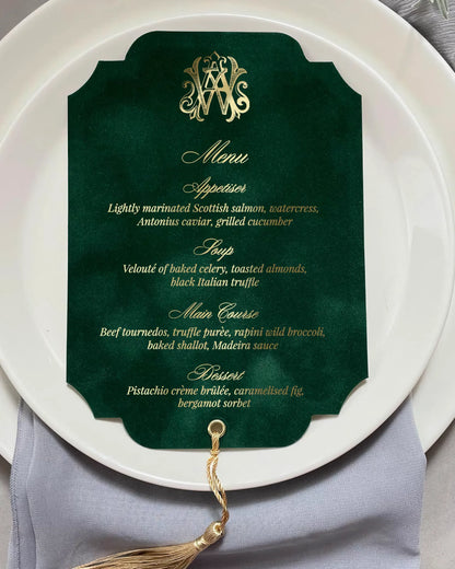 Luxury wedding menu card crafted from forest green velvet with a die-cut vintage frame shape, shimmering gold foil hot pressed text, and a golden silk tassel — Polina Perri