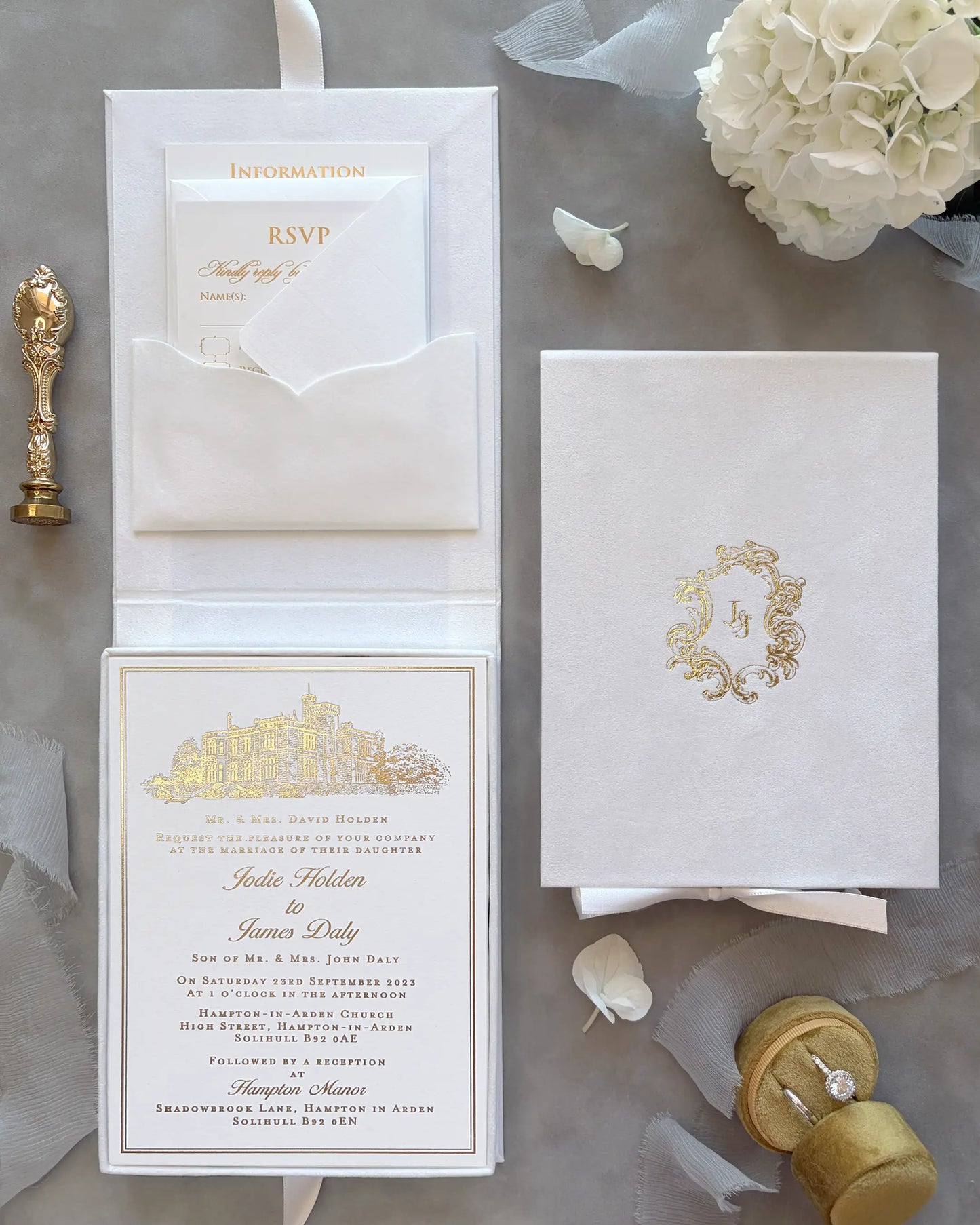White Velvet Boxed Hampton Manor wedding invitation card by Polina Perri, clear acrylic wedding invitation with elegant gold foil lettering held in hand close up