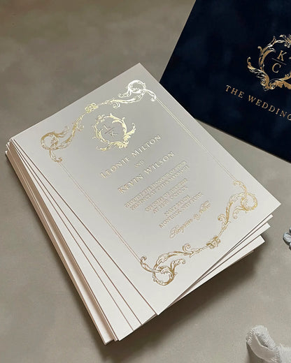 A stack of luxury Isabelle wedding invitations showcasing the premium thickness and tactile quality of the 600gsm cotton card stock with gold foiled edges — Polina Perri