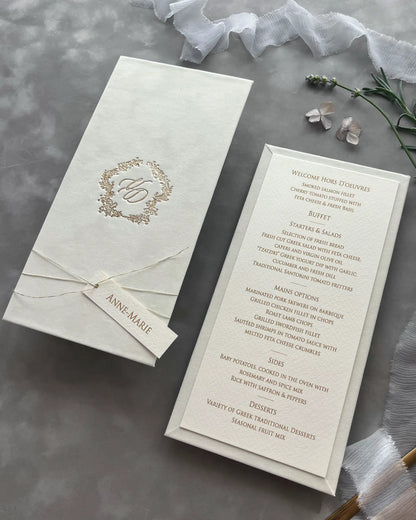Premium ivory velvet wedding invitation and menu set decorated with fine twine, a personalized name tag, and a gold foil floral monogram wreath — Polina Perri