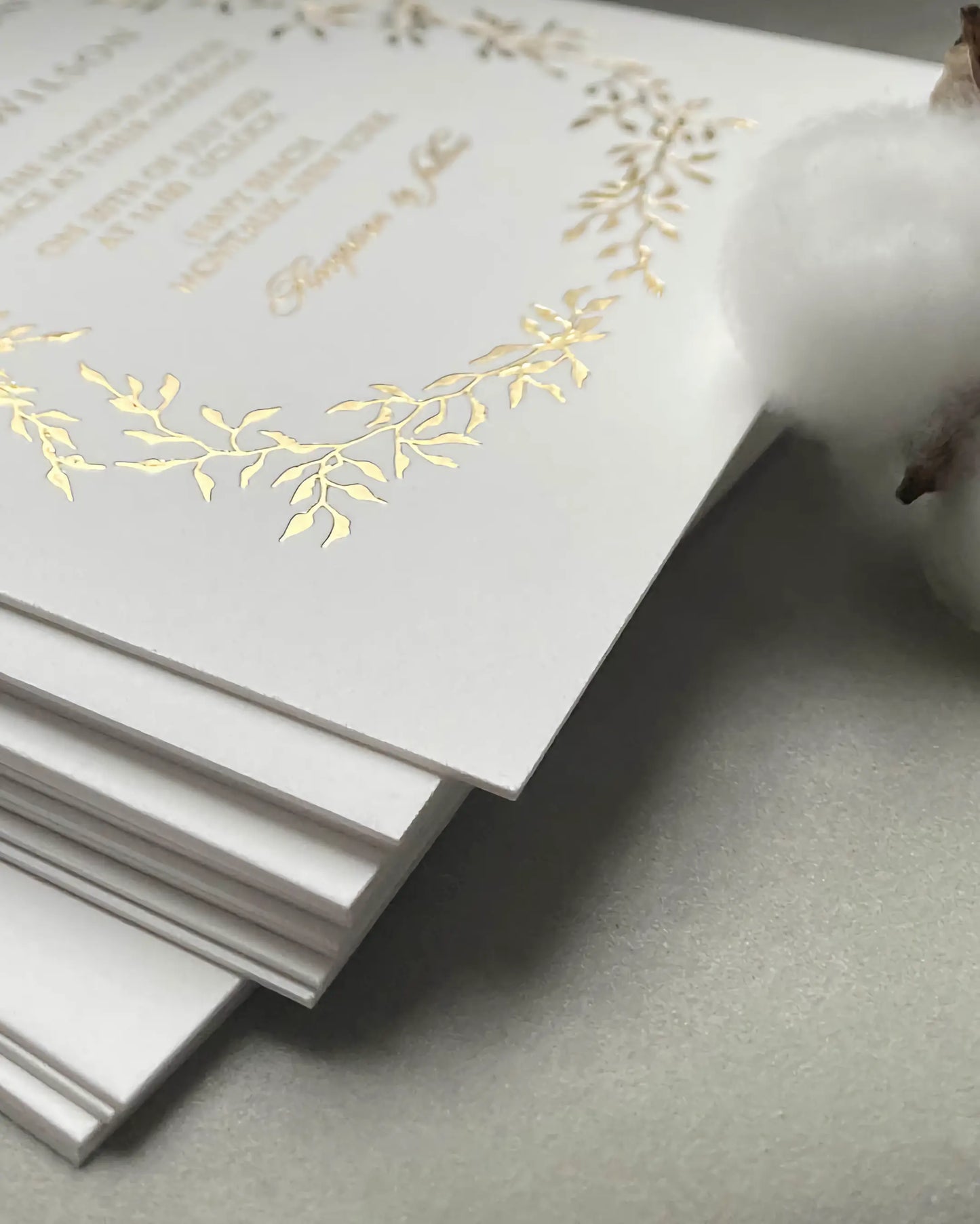 Extreme close-up focusing on the heavy, tactile texture of the ultra-thick 600gsm 100% cotton card stock used for luxury foil pressed wedding invitations — Polina Perri