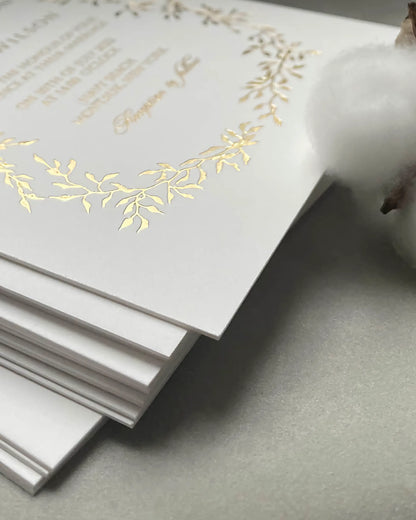 Extreme close-up focusing on the heavy, tactile texture of the ultra-thick 600gsm 100% cotton card stock used for luxury foil pressed wedding invitations — Polina Perri