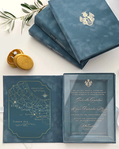 Dusty Blue wedding invitation set with gold details on a white surface