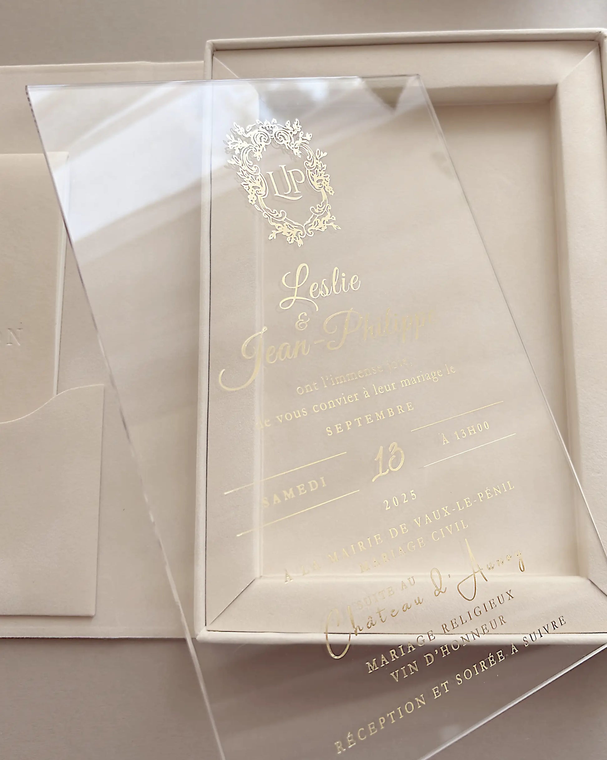 Luxury clear acrylic wedding invitation card with custom gold foil French lettering and floral crest monogram detailing — Polina Perri