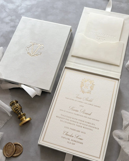 Luxury wedding invitation with a heavy white cardstock option featuring a stunning gold foil stamped floral crest, housed in a cream velvet monogram box — Polina Perri