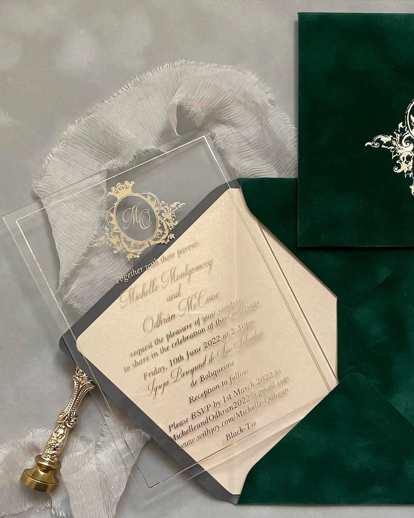 Vienna Gold Acrylic wedding invitation with gold foil crest and Forest Green velvet envelope styled flat lay — Polina Perri