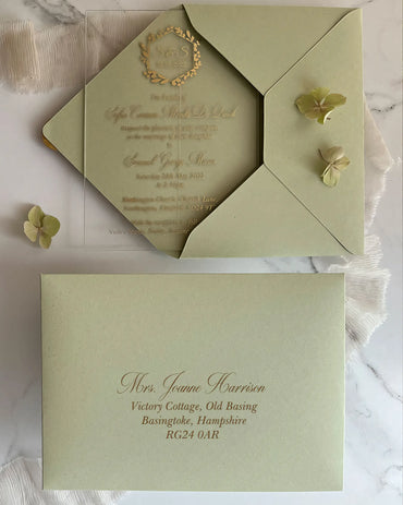 Eucalyptus Minimalist Acrylic wedding invitation with Sage Green envelope and addressing flat lay — Polina Perri