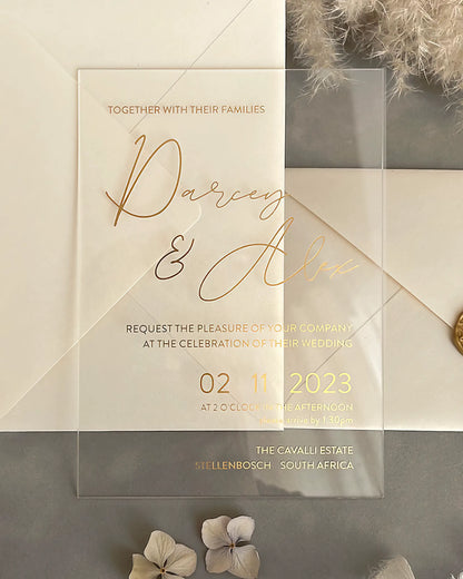 Modern Chic Acrylic wedding invitation with gold foil lettering and cream envelope styled flat lay — Polina Perri