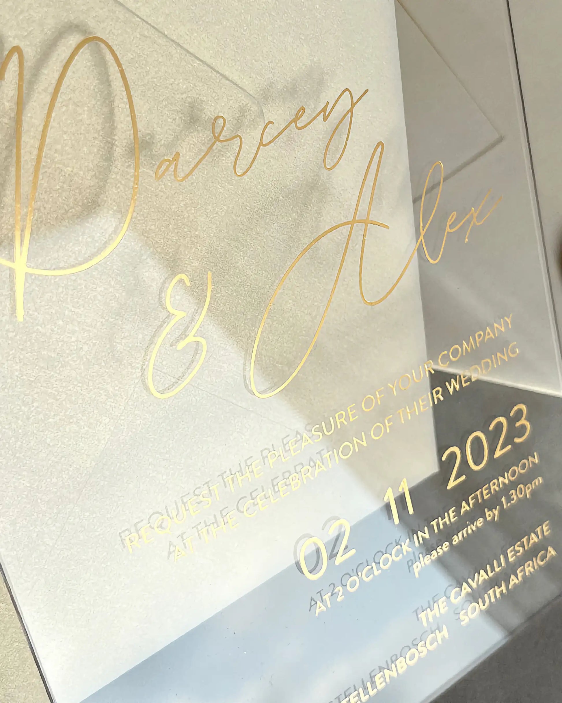 Modern Chic Acrylic wedding invitation close-up with gold foil script lettering on clear acrylic — Polina Perri