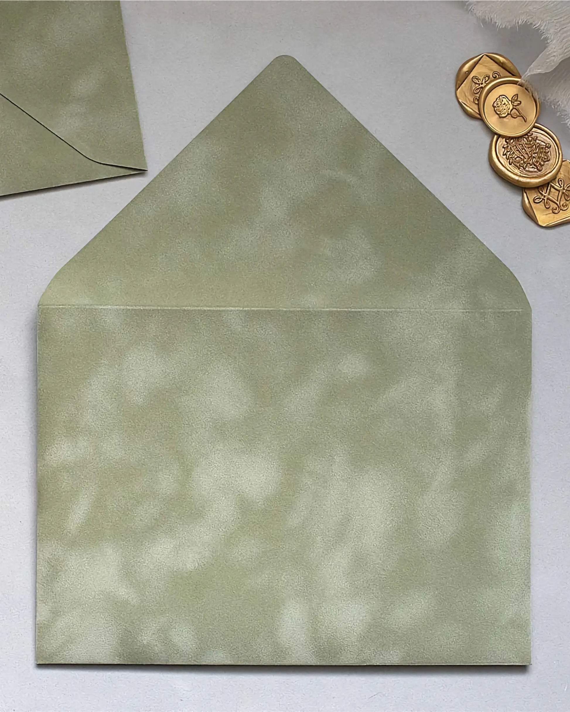 Sage Green velvet envelope flat lay close-up — Polina Perri