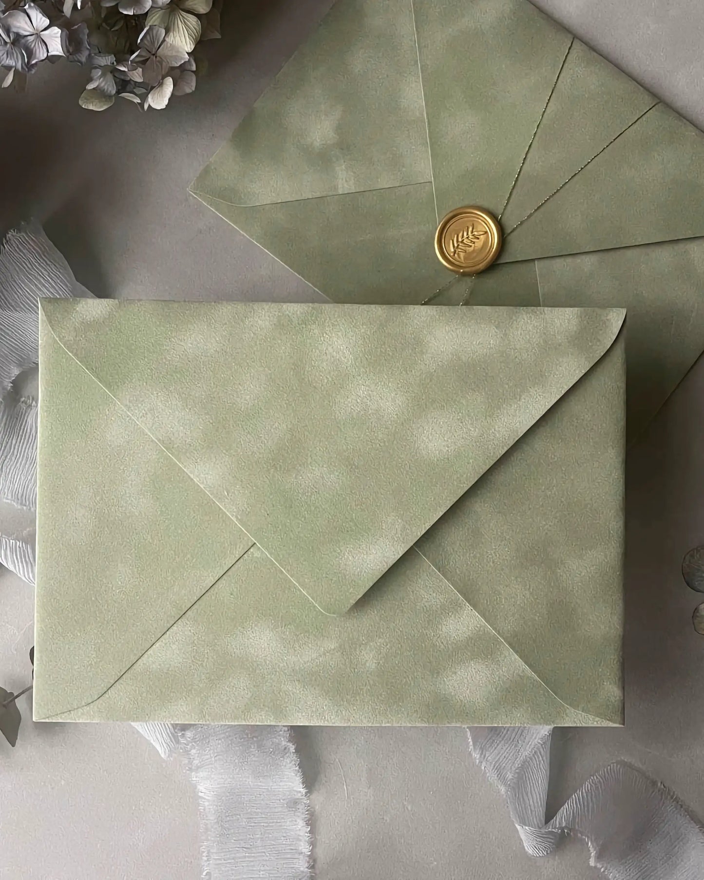 Sage Green velvet envelope with gold wax seal flat lay close-up — Polina Perri