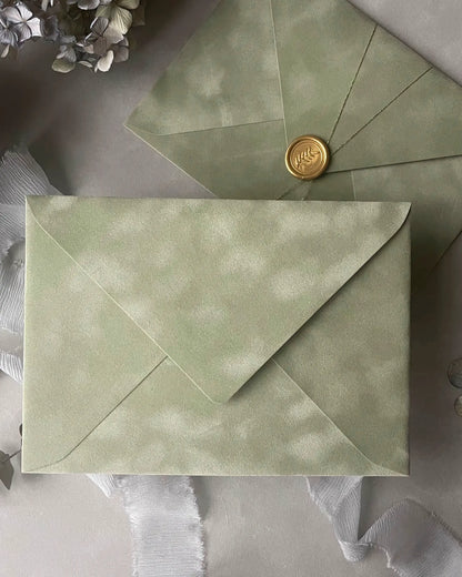 Sage Green velvet envelope with gold wax seal flat lay close-up — Polina Perri