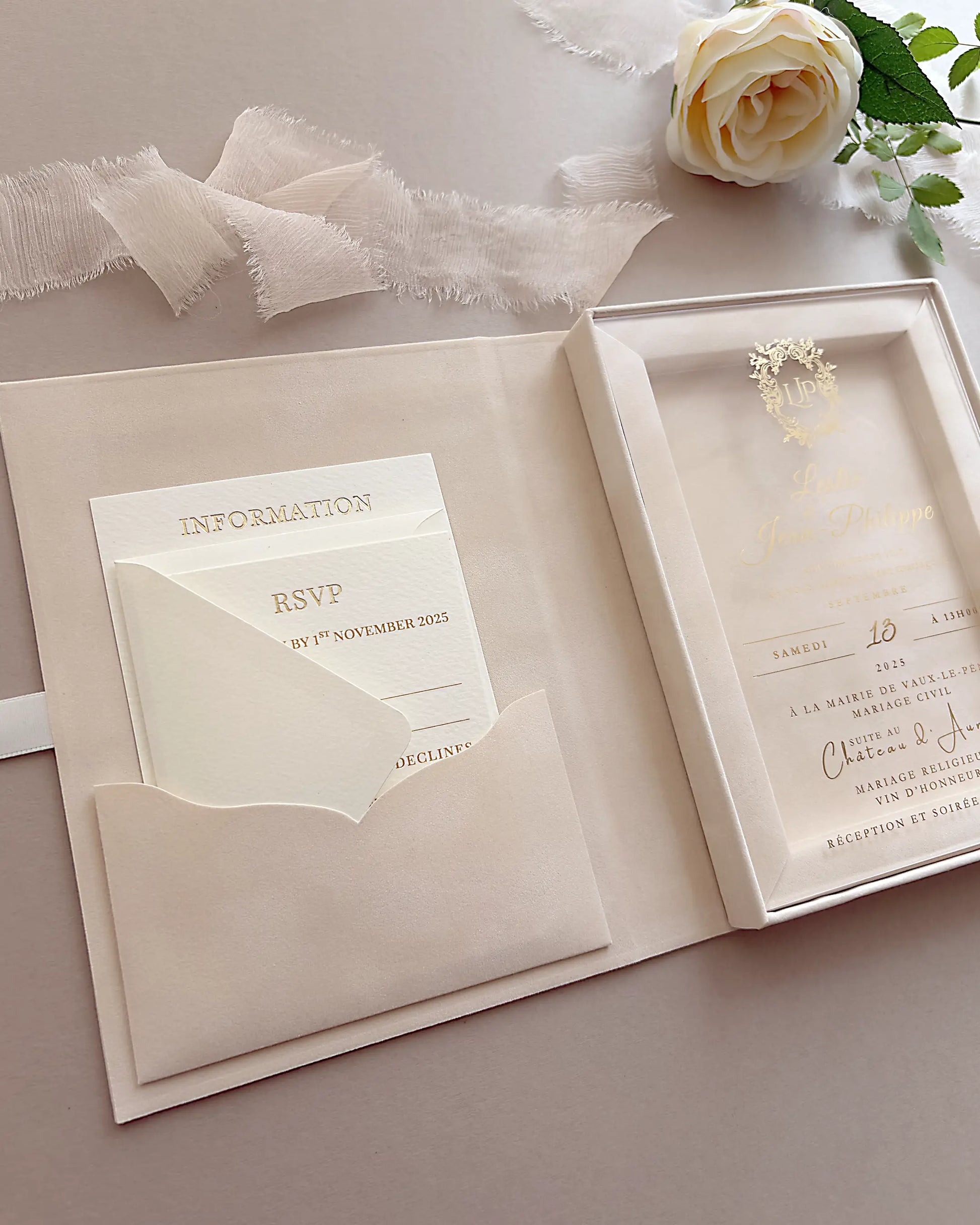 Open Vienna blush velvet wedding invitation box featuring an internal pocket for RSVP cards next to a clear acrylic invitation and a white rose — Polina Perri