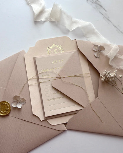 Blush pink velvet wedding invitation card bundled with enclosure inserts using a delicate gold thread tie inside an open ribbed paper envelope — Polina Perri