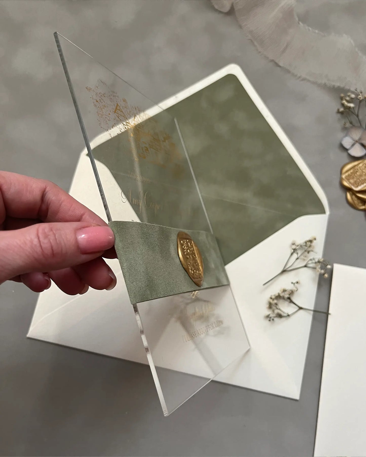 Venue Acrylic and Velvet Liner wedding invitation with Sage Green velvet envelope and gold wax seal held in hand — Polina Perri