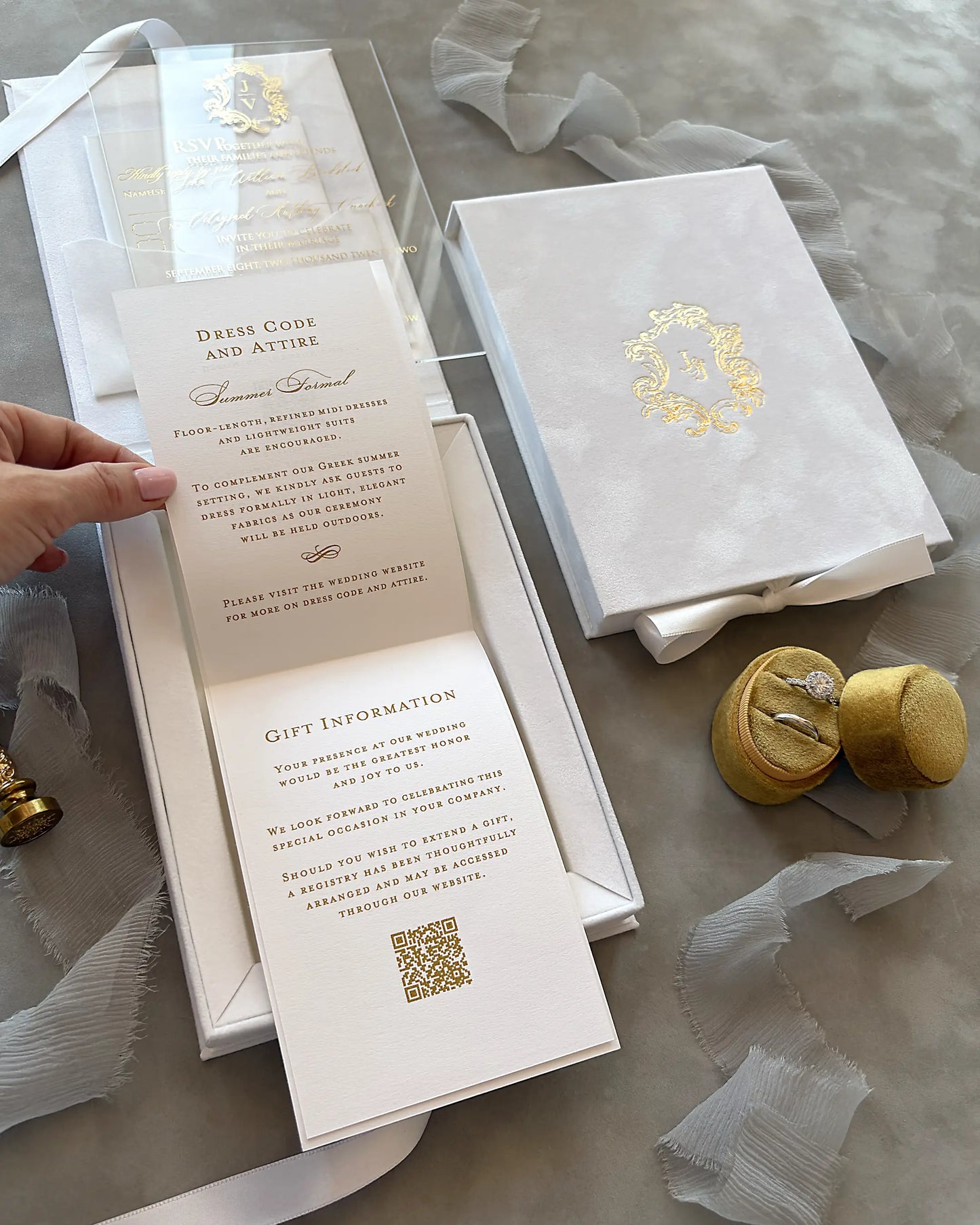 White Velvet Boxed Hampton Manor wedding invitations by Polina Perri, vertical view of opened white velvet invitation box showcasing tiered information cards with gold foil text