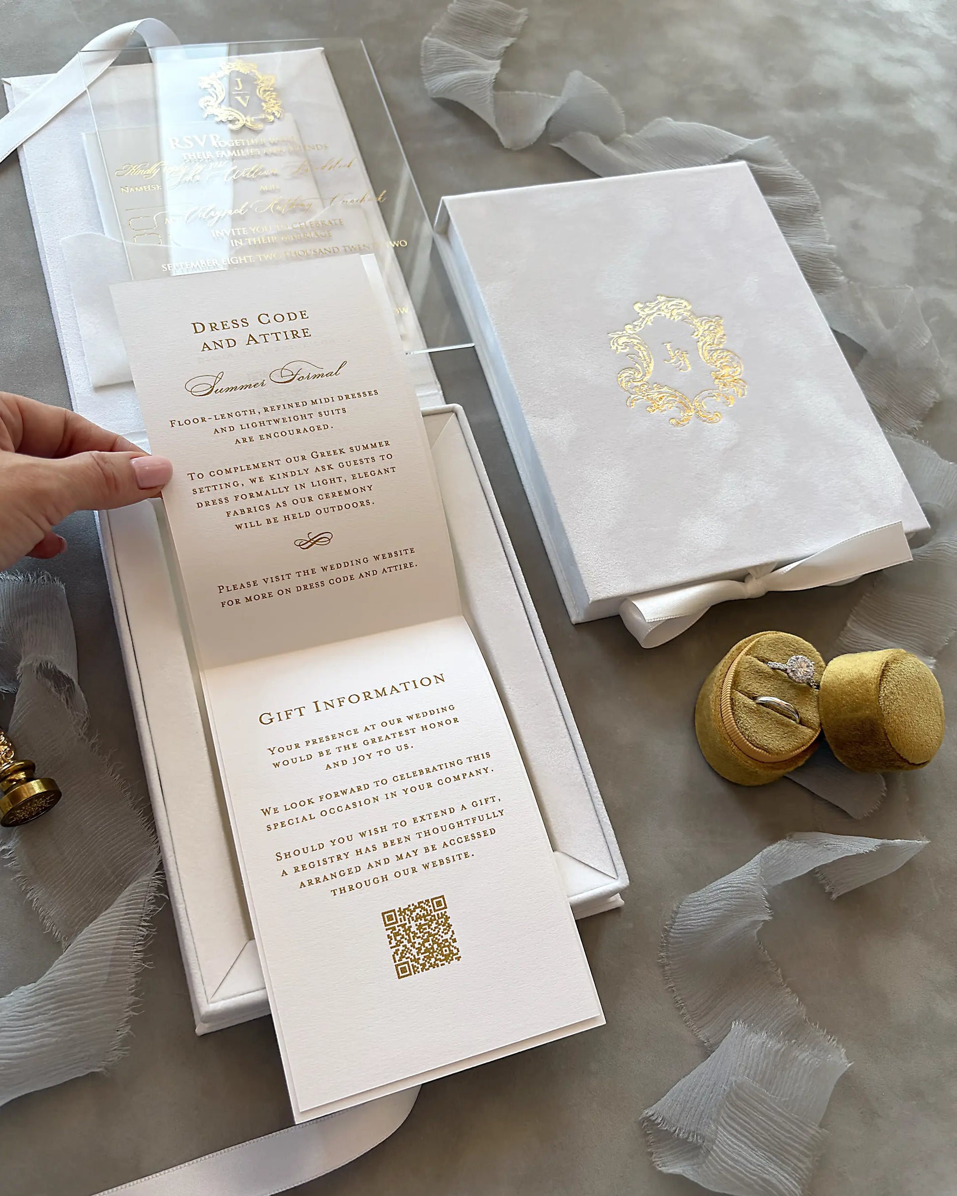White Velvet Boxed Hampton Manor wedding invitations by Polina Perri, vertical view of opened white velvet invitation box showcasing tiered information cards with gold foil text