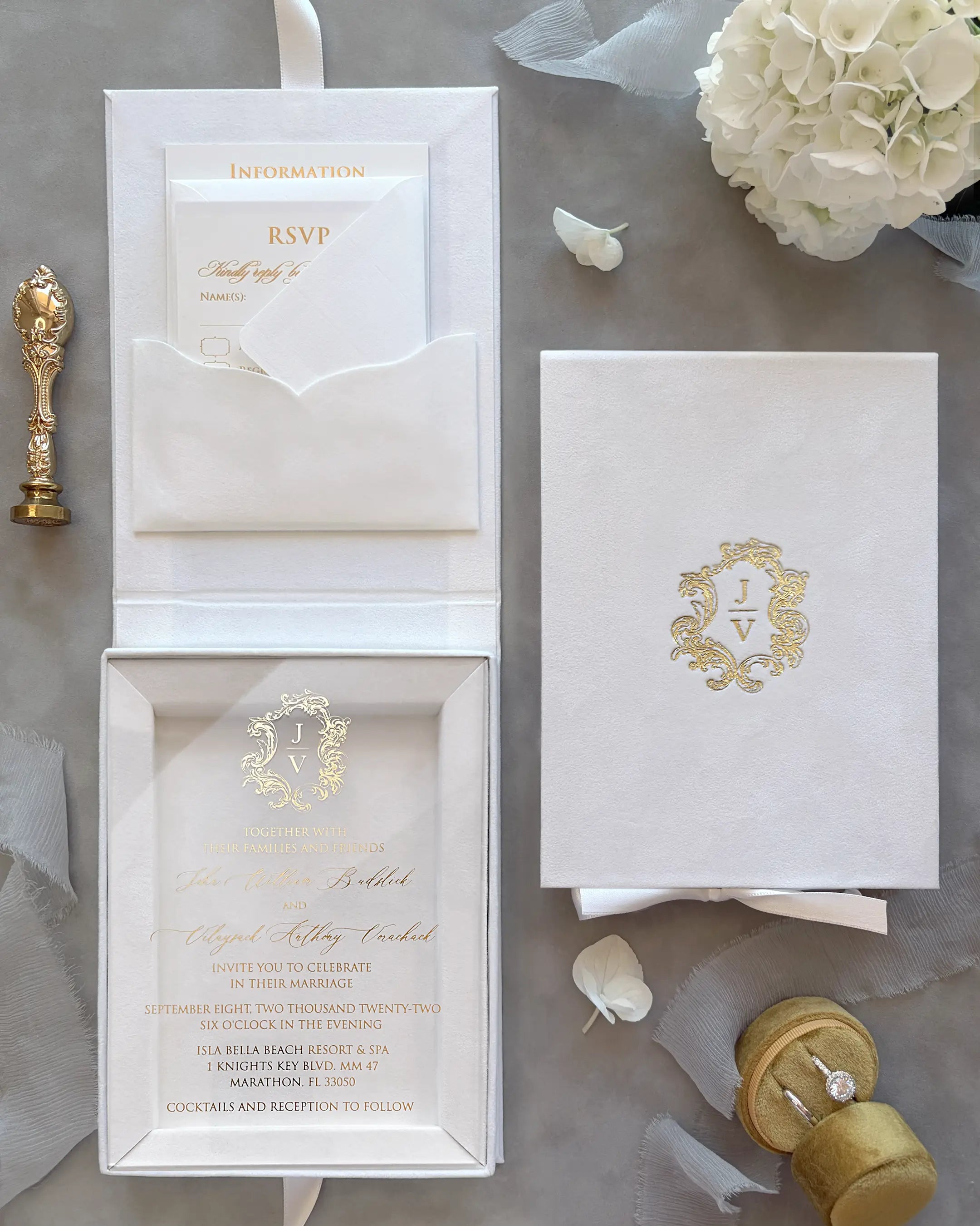 White Velvet Boxed Hampton Manor wedding invitations by Polina Perri, luxury clear acrylic invitation suite with gold foil monogram in white velvet presentation box on grey textile background